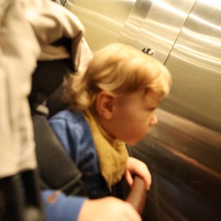 Child in Elevator with Adult Companion