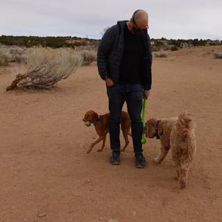 Walking Man with Two Dogs in the Desert