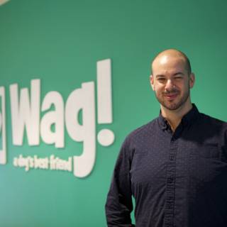 The Smiling Man in Front of the WAG Logo