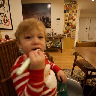 Toddler Eating at Home in Red Striped Pajamas