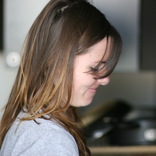 Windswept Hair Cascading Over a Smiling Face