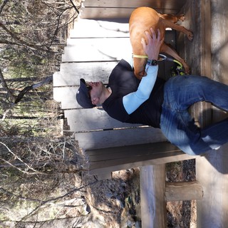 Man and Dog Resting on Park Bench