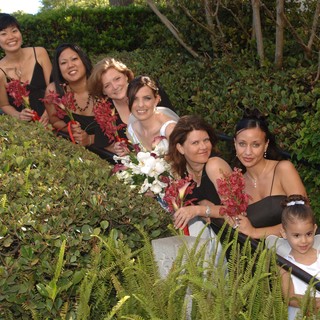 Bridal Party Poses Among Garden Greenery at Wedding