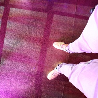 Looking Down at Sneakers on Dance Floor Carpet