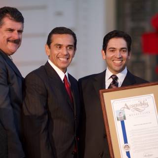 Four Men in Suits Receiving a Certificate