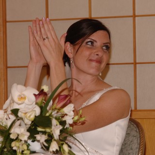 Bride Clapping Joyfully at Wedding Reception