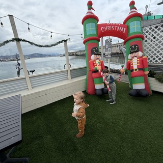 Children Playing by Christmas Inflatable Display at Waterfront