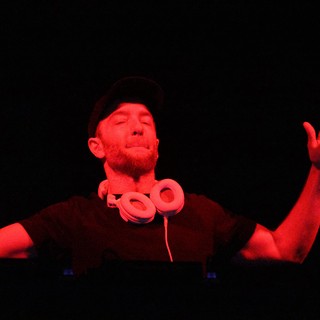 DJ Lost in the Music Under Red Lights