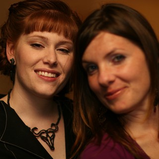 Two Smiling Women Share a Warm Moment Together