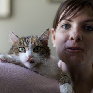 Woman and Curious Tabby Cat Share a Moment