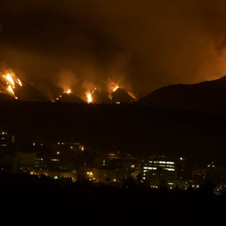 Flames Engulf Cityscape and Mountain Landscape