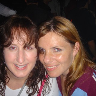 Two Friends Smiling Together at a Social Event