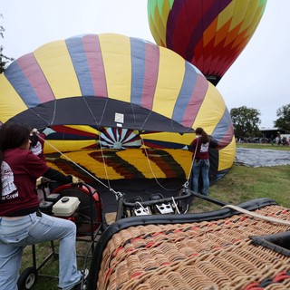 Ground Crew Inflating Hot Air Balloons at Festival