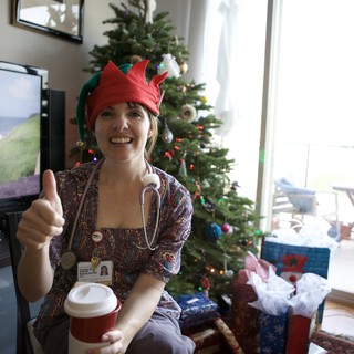 Festive Nurse Elf Celebrates Christmas with Thumbs Up