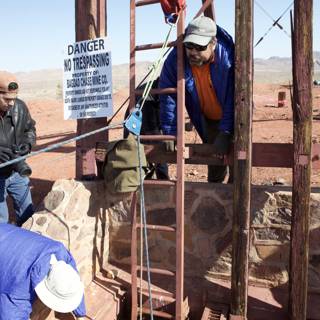 Three Workers Repair Walkway in Desert