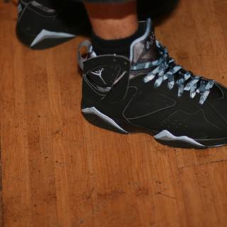 Black and Silver Sneakers on Hardwood
