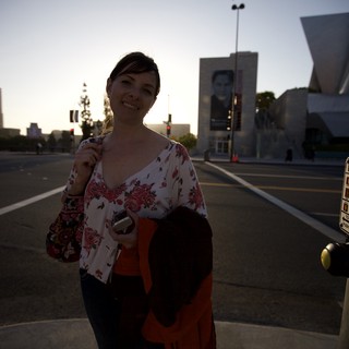 Woman Smiling at Downtown LA Crosswalk at Dusk