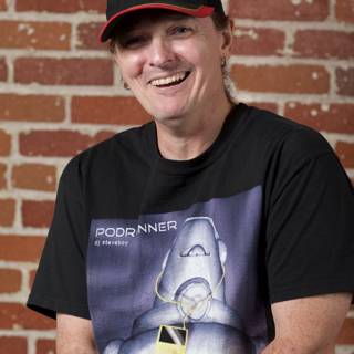 Smiling Man in Black Hat and T-Shirt