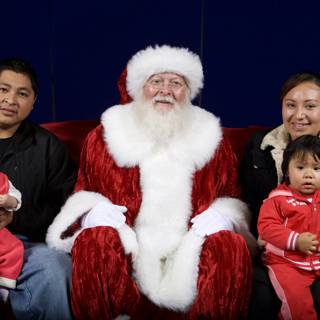 Christmas Cheer: Smiling Family Poses with Santa Claus