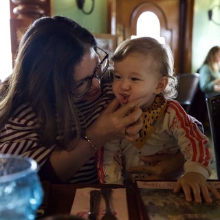 Mother and Child Sharing Sweet Moment at Restaurant