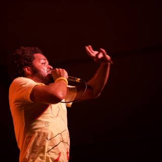 Yellow-Shirted Performer Takes the Stage with Microphone