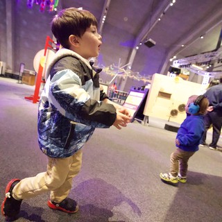 Young Boy Explores Interactive Science Museum Exhibit