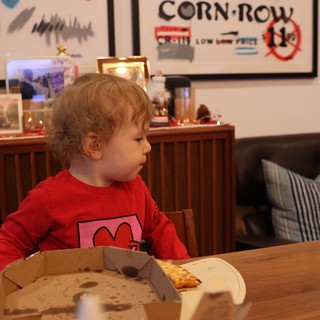 Young Child Enjoying Pizza at Home During Christmas