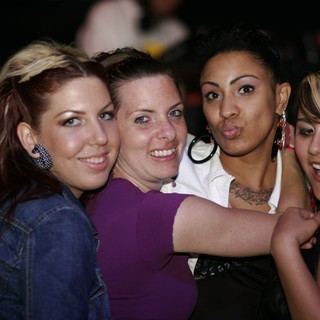 Four Friends Celebrating Together at a Nightclub