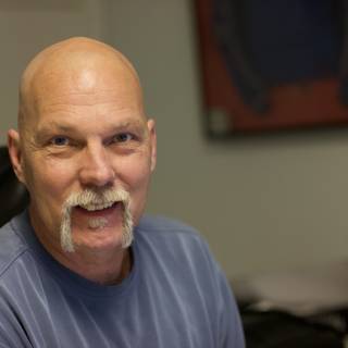 Smiling Bald Man with a Mustache
