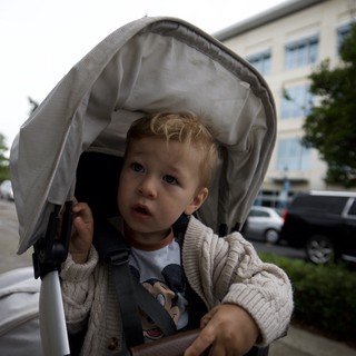 Curious Toddler in Stroller on Overcast Day