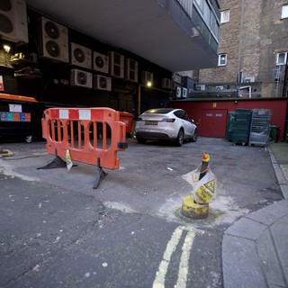 Urban Alley Construction Site with White SUV