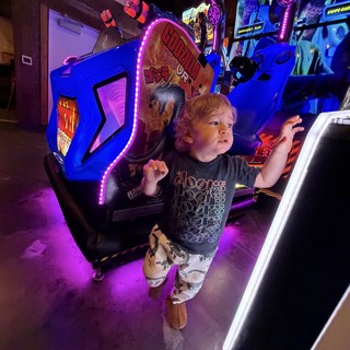 Young Gamer Immersed in Arcade Action