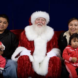Smiling Family with Santa Claus