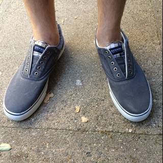 Grey Sneakers on a Sunny Sidewalk