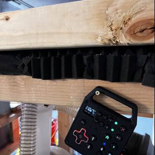 Remote Control on Wooden Beam