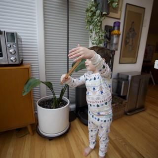 Child in Holiday Pajamas Playing Indoors