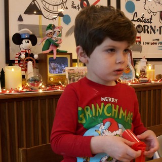 Child Opening Christmas Presents on Christmas Eve