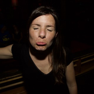 Woman Making a Playful Face at Night Event