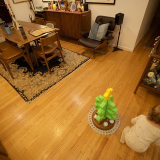 Toddler Playing with Christmas Tree Toy in Living Room