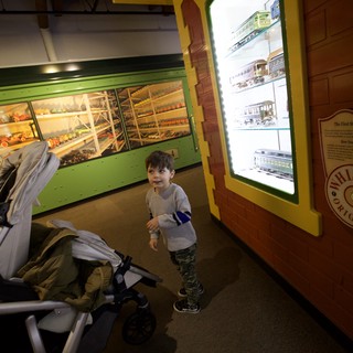 Young Child Explores Train Museum Display