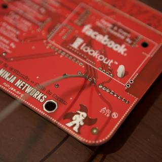 Red Circuit Board with a Ninja Badge Sticker