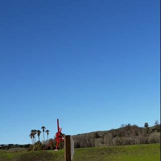 Red Windmill in a Serene Grassland