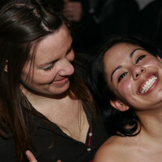 Two Women Laughing Together at Nighttime Event