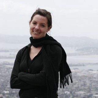 Woman Smiling Atop Hill Overlooking San Francisco Bay