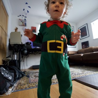 Toddler in Festive Elf Costume at Home