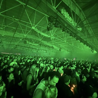 Green-Lit Crowd at Electronic Music Concert