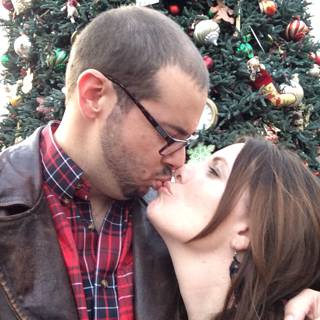 Romantic kiss in front of Christmas tree