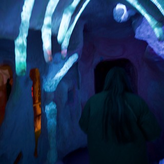Visitors in Ice Cave with Blue Projected Light