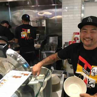 Smiling Chef with Tattoos Holds Bowl of Deliciousness