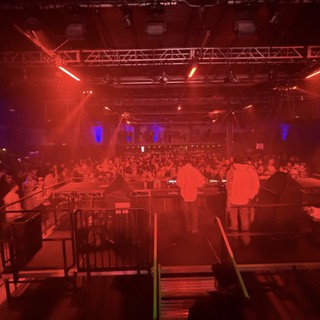 Electronic Music Event with Red Stage Lighting and Crowd
